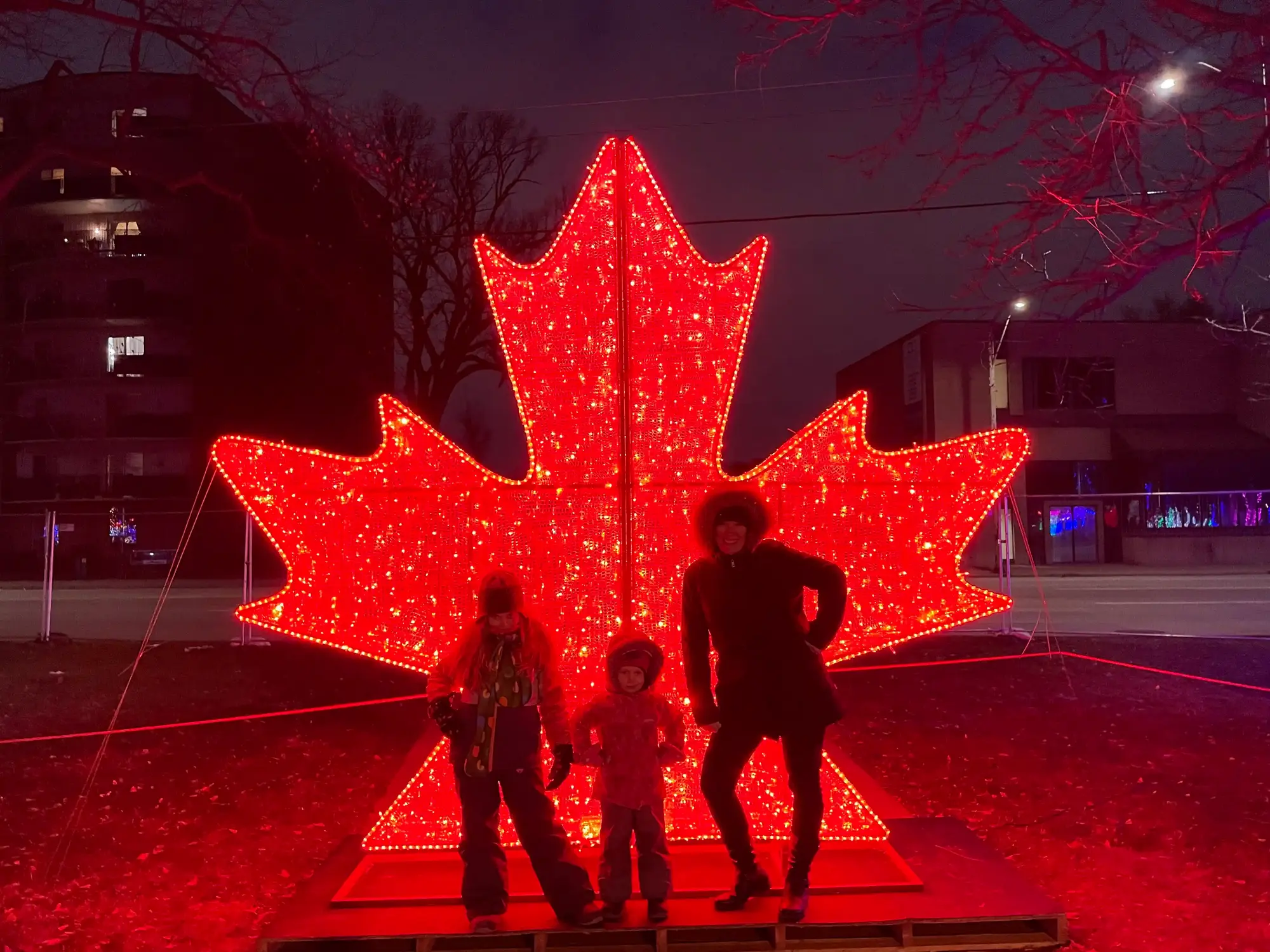 Large illuminated red maple leaf display used as a Canada Day photo opportunity for municipal events and community celebrations.